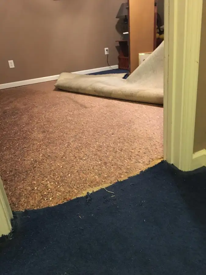Carpet pad removal revealing water damage during Water Mitigation Services in Hyrum